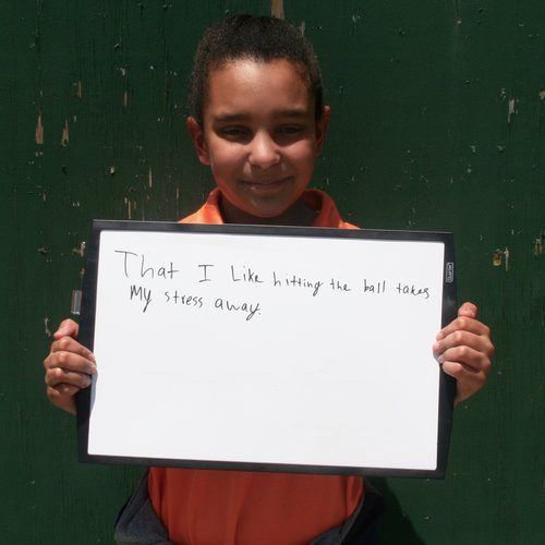 young girl holding a sign
